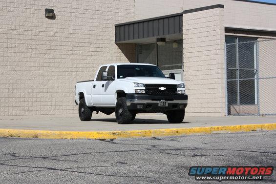 White pickup truck parked outside a building. License plate says CAT