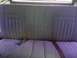 1979 Ford Bronco - The interior rear seat features a patterned fabric with a seatbelt visible on the cushion.