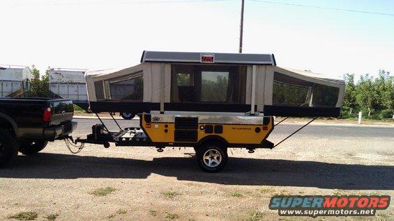Yellow pop-up camper trailer side view