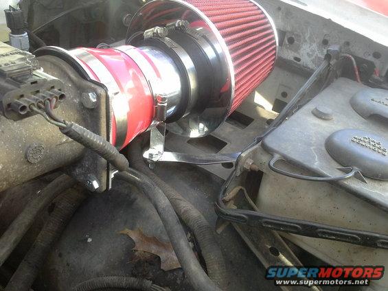 20140913_154450.jpg Universal bracket in the kit. I used the existing air box screw and bent a 90 degree in the bracket to fit