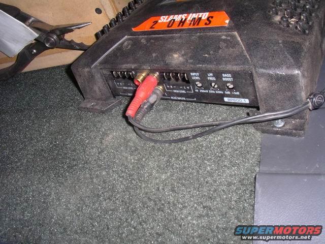 Car stereo amplifier with red and black RCA cables connected
