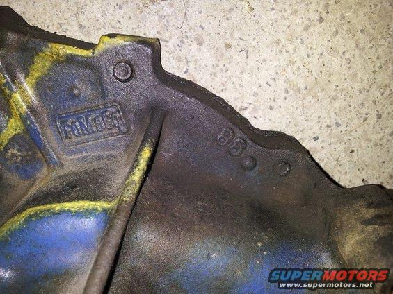 Cast iron Ford part with yellow and blue paint, showing 'FORD' logo and '68' casting date