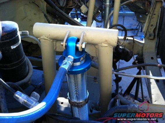 Blue Koni shock absorber in engine bay with custom tubing