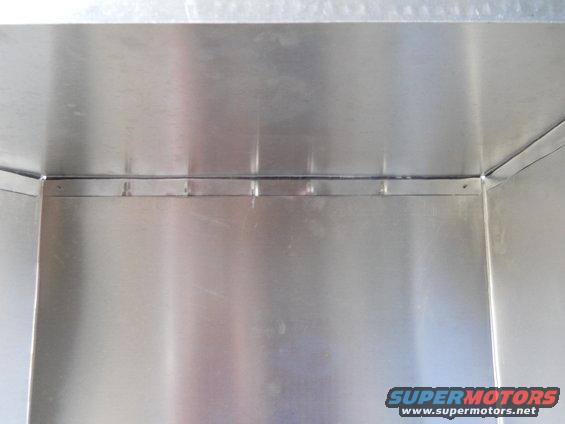 inside of a metal box with visible seams and rivets