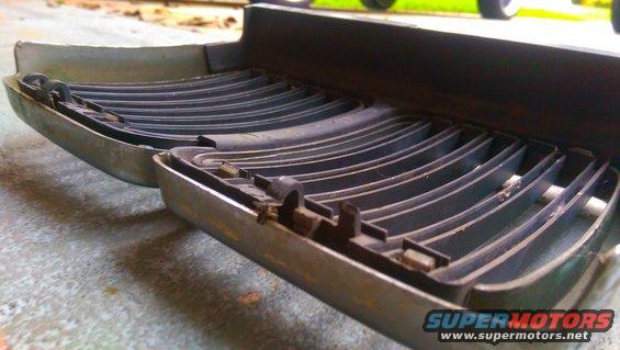 Close-up of a car grille section with horizontal slats and metal trim