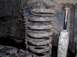 1990 Ford F-150 - Vehicle suspension components, including a coil spring and shock absorber, are shown in this close-up view.