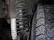 1990 Ford F-150 - Close-up view of a vehicle's front suspension system, showing a coil spring and shock absorber.