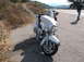 2011 Harley-Davidson Elec Gld Police - A white 2011 Harley-Davidson Electra Glide is parked on the side of a road, with another motorcycle and a person visible in the background.