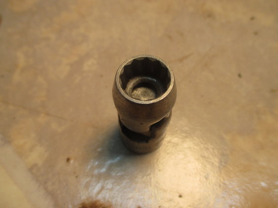 Close-up of a metal socket wrench extension joint with a 12-point opening