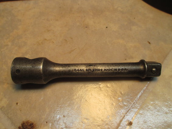 Metal socket extension with "5461 GPLYMBQ MADE IN U.S.A." stamped on it