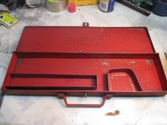Red metal toolbox with "STROM TOOL CO LOS ANGELES" stamped on lid