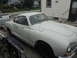 1969 Volkswagen Karmann Ghia - A white 1969 Volkswagen Karmann Ghia coupe is seen on a trailer, with a house and street in the background.