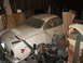 1969 Volkswagen Karmann Ghia - A dusty 1969 Volkswagen Karmann Ghia sits in a cluttered garage, awaiting restoration.