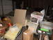 1969 Volkswagen Karmann Ghia - Interior view of a car in a cluttered garage, surrounded by various items and storage boxes.
