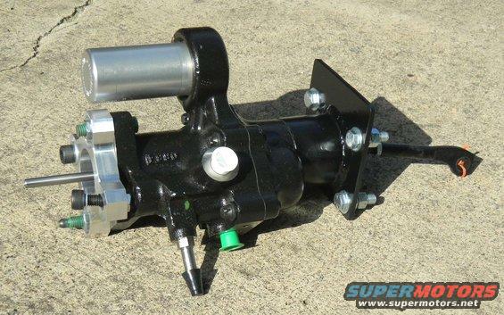 Black power steering gearbox with silver cylinder and metal bracket