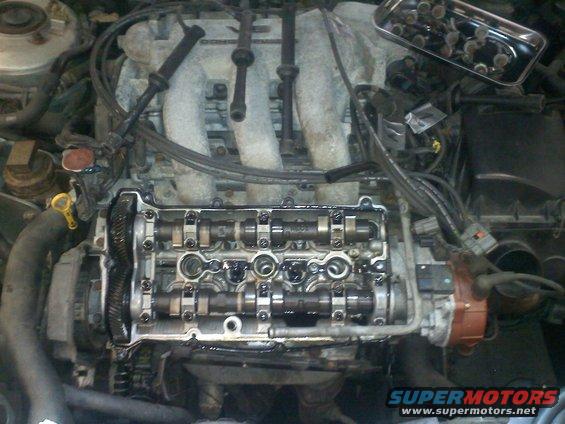 Engine with valve cover removed, showing camshafts and spark plug wires