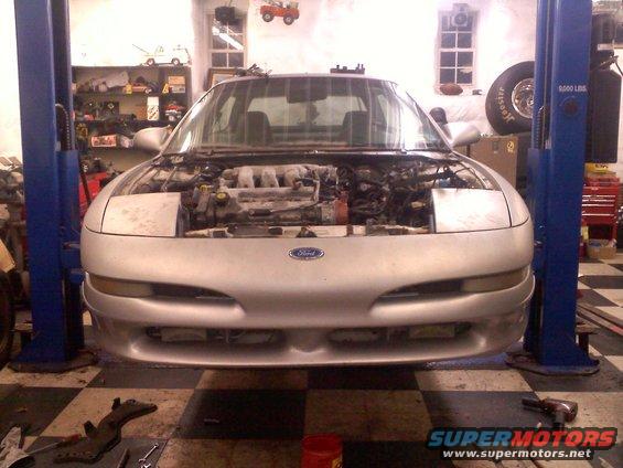 Silver 1993 Ford Probe front view on lift, engine exposed