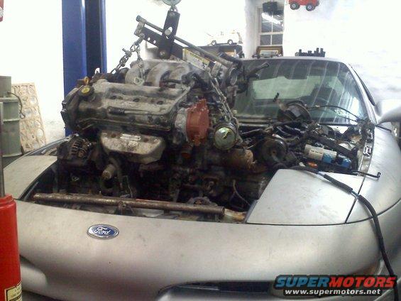 Silver 1993 Ford Probe GT with engine being removed
