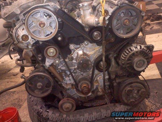 Engine assembly with belts and pulleys visible