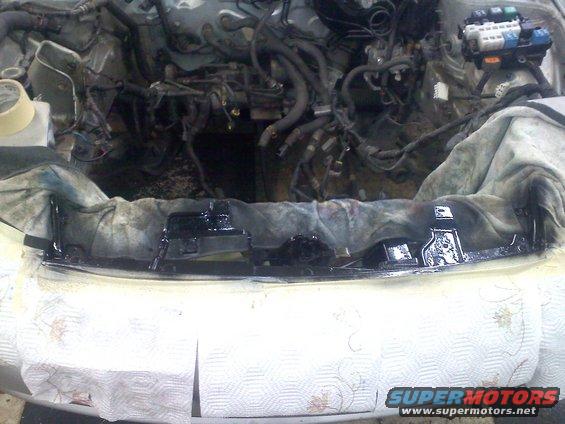 Engine bay with parts removed, showing wiring and engine components