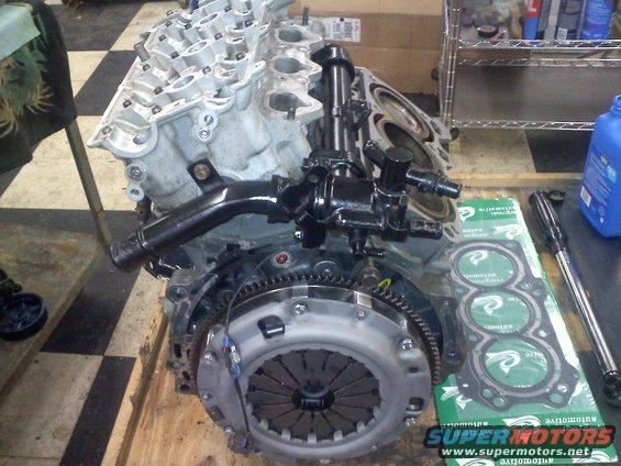 Engine block with clutch assembly and three-ring gasket set on a wooden surface
