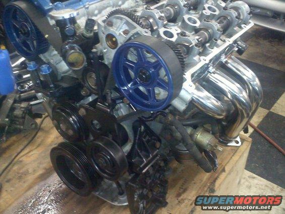 Engine with blue timing belt pulleys and chrome exhaust manifold