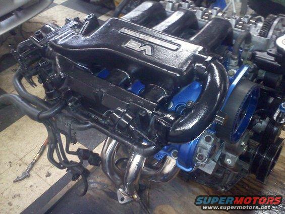V6 engine with black intake manifold and blue accents