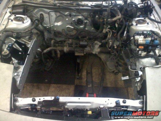 Engine bay with wiring and components visible