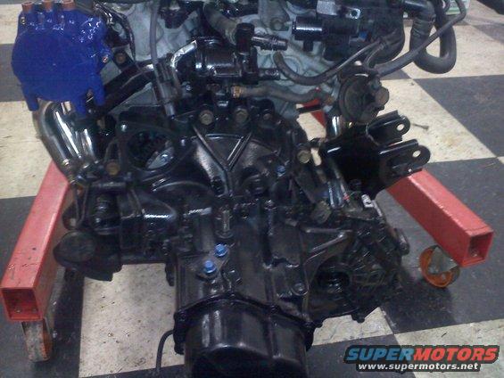 Engine and transmission assembly mounted on a red engine stand