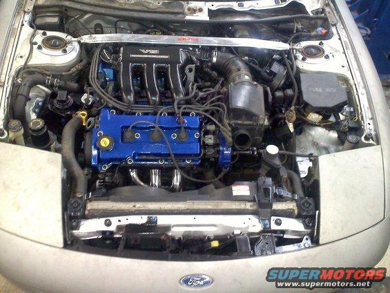 Engine bay with V6 badge and blue valve covers