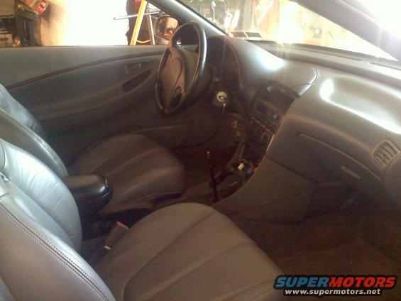 Gray leather interior of a 1993 Ford Probe, showing the dashboard, steering wheel, center console, and front seats