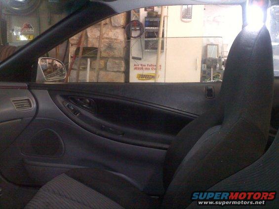 Interior driver side door panel and seat, black fabric