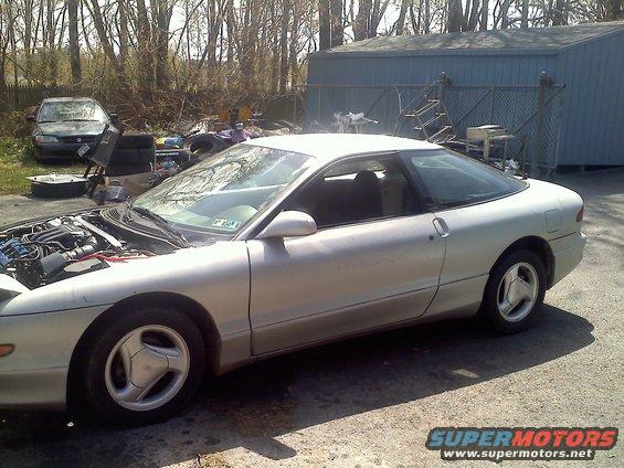 1993 Ford Probe GT coupe with hood open, parked outside next to another car
