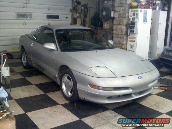 Silver 1993 Ford Probe GT parked in a garage with a checkered floor