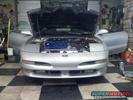 Silver 1993 Ford Probe front view, hood and doors open, engine exposed