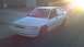 1993 Mercury Tracer - A white 1993 Mercury Tracer sedan is parked on a street with the sun setting behind it.