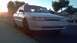 1993 Mercury Tracer - A white 1993 Mercury Tracer sedan is parked on a residential street during sunset.