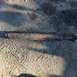 1979 Ford Bronco - A rusty driveshaft lies on a cracked asphalt surface, with a watermark for Supermotors.net visible.