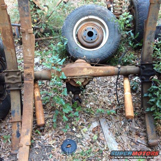 Rear axle assembly with leaf springs and shock absorbers, rusty