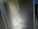 1992 Ford Bronco - The interior of a metal box structure, possibly a cargo area, with a portion of a blue vehicle visible.