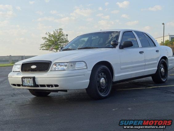 White 2007 Ford Crown Victoria sedan with black grille and steel wheels, parked on asphalt