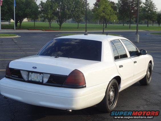 White 2007 Ford Crown Victoria sedan, rear view. License plate ML1-V1D