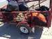 1979 Ford Bronco - A trailer loaded with trash bags and debris sits on a sandy beach, likely after a cleanup event.