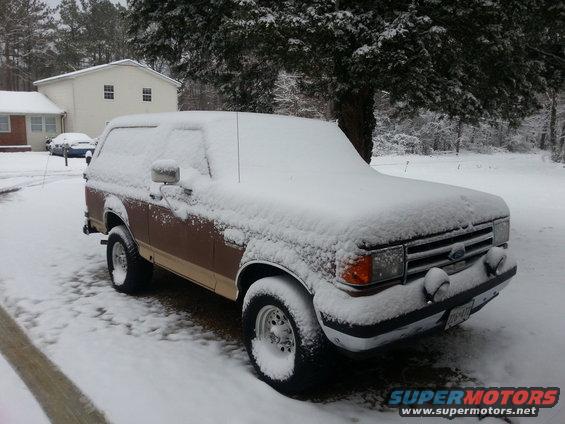1991 Ford Bronco in snow, 3q-front view, brown and tan