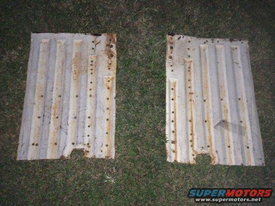 two rusty, ribbed metal floor pans with many small holes