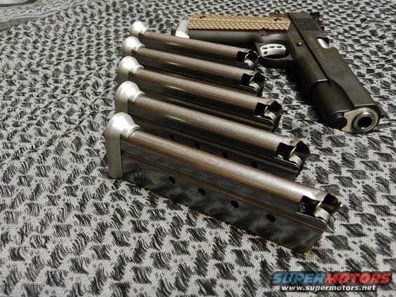 Springfield RO 1911 9mm pistol and five magazines on a patterned cloth