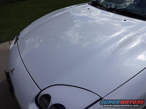 White 1995 Mitsubishi 3000GT front fender and hood with reflections