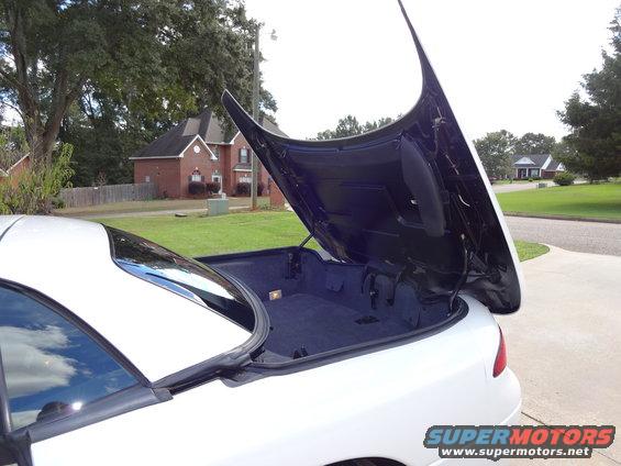 1995 Mitsubishi 3000GT with trunk open, showing carpeted storage area