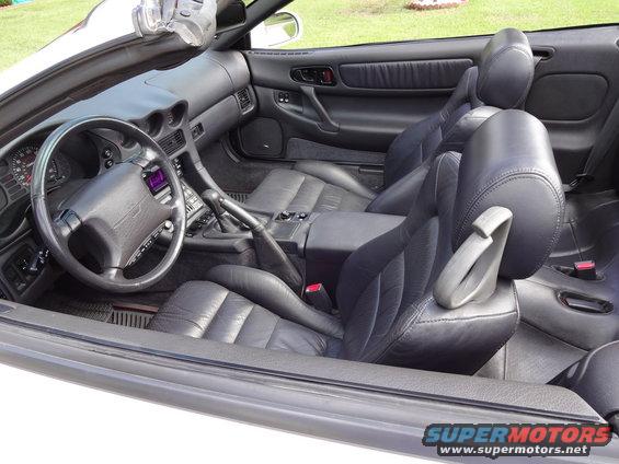 Mitsubishi 3000GT interior with black leather seats, steering wheel, and center console