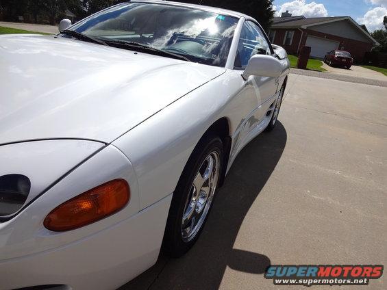 White 1995 Mitsubishi 3000GT parked on a driveway, front quarter view
